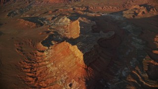 AX138_344 - 5.5K aerial stock footage of approaching a butte in Lockhart Canyon, Moab, Utah, sunset