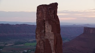 AX138_424 - 5.5K stock footage aerial video of circling around rock climbers on Castleton Tower, Moab, Utah, sunset