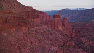 AX138_439E - 5.5K aerial stock footage fly past Ancient Art, reveal Echo Tower, The Titan at Fisher Towers, Utah, twilight