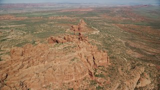 AX139_001E - 5.5K aerial stock footage of flying over rock formations and desert valley, Arches National Park, Utah