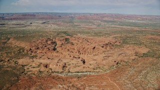 AX139_006E - 5.5K aerial stock footage of passing desert rock formations, Arches National Park, Utah