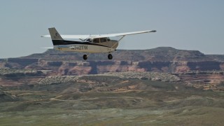 AX139_023E - 5.5K aerial stock footage of tracking a Cessna flying over the desert, Grand County, Utah