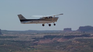 AX139_025 - 5.5K aerial stock footage of tracking a Cessna flying over the desert, Grand County, Utah