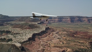 AX139_026E - 5.5K aerial stock footage of tracking Cessna flying over desert in Grand County, Utah