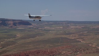AX139_027 - 5.5K aerial stock footage of tracking Cessna flying over desert in Grand County, Utah