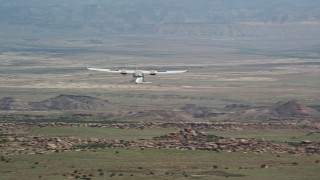 AX139_036E - 5.5K aerial stock footage of tracking Tecnam P2006T over desert, zoom to reveal Cessna, Grand County, Utah