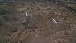 AX139_044 - 5.5K aerial stock footage of Tecnam P2006T and Cessna flying together over desert, Grand County, Utah
