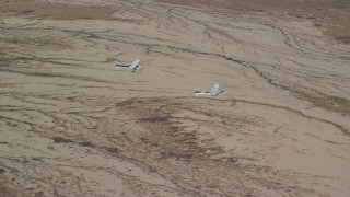 AX139_051 - 5.5K aerial stock footage of Tecnam P2006T, Cessna airplanes flying over desert, zoom in, Grand County, Utah