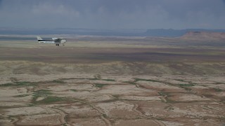 AX139_061 - 5.5K aerial stock footage focus on Cessna over desert, reveal Tecnam P2006T, Grand County, Utah