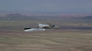 AX139_062 - 5.5K aerial stock footage of a Tecnam P2006T flying over desert, Grand County, Utah