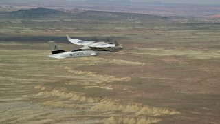 AX139_062E - 5.5K aerial stock footage of tracking Tecnam P2006T flying over desert, Grand County, Utah