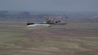 AX139_063 - 5.5K aerial stock footage of tracking Tecnam P2006T flying over desert, Grand County, Utah
