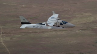 AX139_065 - 5.5K aerial stock footage of tracking Tecnam P2006T airplane flying over desert, Grand County, Utah