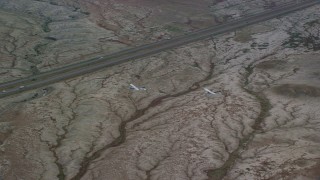 AX139_069 - 5.5K aerial stock footage of tracking Tecnam P2006T, Cessna over desert near Highway 6, Grand County, Utah