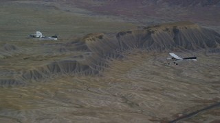 AX139_071 - 5.5K aerial stock footage of Tecnam P2006T, Cessna over desert near a highway, Grand County, Utah