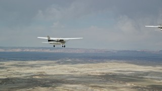 AX139_081E - 5.5K aerial stock footage tracking Cessna airplane over desert, revealing Tecnam P2006T, Grand County, Utah