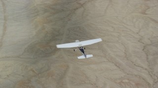 AX139_085 - 5.5K aerial stock footage of air to air view of Tecnam P2006T and Cessna flying over desert, Grand County, Utah