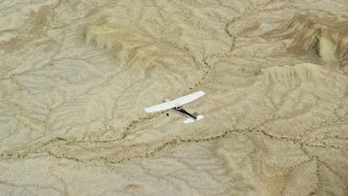 AX139_086 - 5.5K aerial stock footage of an air to air view of a Cessna flying over desert, Grand County, Utah