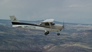 AX139_146E - 5.5K aerial stock footage of a view of a Cessna over desert mountains, seen from above, Carbon County, Utah