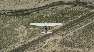 AX139_153E - 5.5K aerial stock footage of a bird's eye view of a Cessna plane flying over desert, Carbon County, Utah