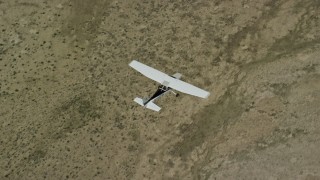 AX139_156E - 5.5K aerial stock footage of a bird's eye of a Cessna plane in flight high over desert, Carbon County, Utah