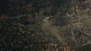 AX140_013E - 5.5K aerial stock footage track a Cessna airplane over desert mountains, Carbon County, Utah