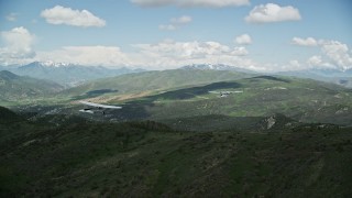 AX140_077E - 5.5K aerial stock footage of following a Tecnam P2006T and Cessna over mountains, Wasatch Range, Utah