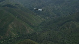 AX140_120E - 5.5K aerial stock footage focus on a Tecnam P2006T near snow-capped peaks in the Wasatch Range, Utah
