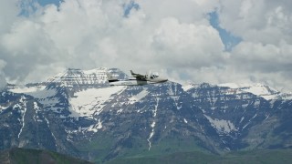 AX140_162E - 5.5K aerial stock footage of flying with a Tecnam P2006T passing snow-capped Mount Timpanogos, Utah