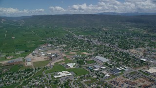 AX140_176 - 5.5K aerial stock footage of approaching small town, pan across neighborhoods, Heber City, Utah