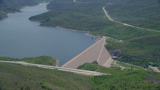 AX140_193 - 5.5K aerial stock footage of circling dam beside a highway, Jordanelle Dam, Utah