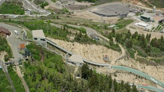 AX140_220E - 5.5K aerial stock footage of orbiting the ski jumps at Utah Olympic Park