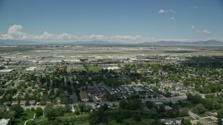 AX140_262E - 5.5K aerial stock footage of approaching Salt Lake City International Airport, Utah