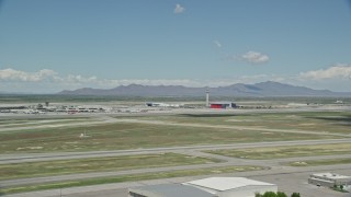 AX140_265E - 5.5K aerial stock footage of the control tower at Salt Lake City International Airport, Utah