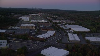 AX141_001 - 5.5K aerial stock footage of a strip mall, warehouse buildings, University Avenue, Westwood, Massachusetts, twilight