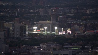 AX141_012E - 5.5K aerial stock footage flying by a baseball game at Fenway Park, Boston, Massachusetts, twilight