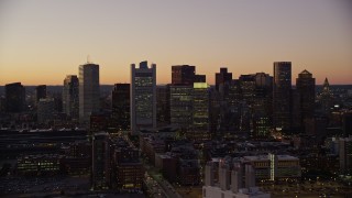 AX141_019E - 5.5K aerial stock footage flying by buildings, skyscrapers, Downtown Boston skyline, Massachusetts, twilight
