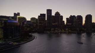 AX141_023E - 5.5K aerial stock footage approaching Two International Place, skyline, Downtown Boston, Massachusetts, twilight