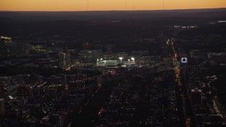 AX141_029 - 5.5K aerial stock footage flying by Fenway Park under lights, Boston, Massachusetts, twilight