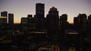 AX141_033E - 5.5K aerial stock footage flying by the skyline at Rowes Wharf, Downtown Boston, Massachusetts, twilight