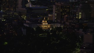 AX141_058 - 5.5K aerial stock footage flying by the Massachusetts State House, Downtown Boston, Massachusetts, night