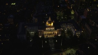 AX141_059E - 5.5K aerial stock footage approaching Massachusetts State House, tilt to bird's eye view, Downtown Boston, Massachusetts, night