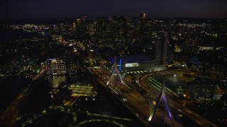 AX141_066E - 5.5K aerial stock footage flying by skyline, approaching Zakim Bridge, Downtown Boston, Massachusetts, night