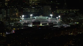 AX141_083 - 5.5K aerial stock footage flying by baseball game in progress, Fenway Park, Boston, Massachusetts, night