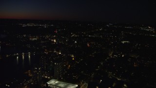 AX141_095E - 5.5K aerial stock footage of a small bridge and Harvard University, Massachusetts, night