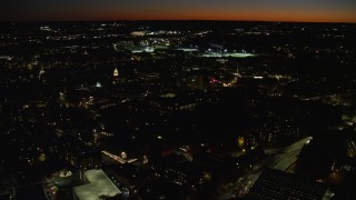 AX141_101 - 5.5K aerial stock footage flying by the campus, sports field, Harvard University, Massachusetts, night