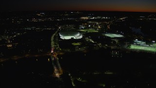 AX141_105 - 5.5K aerial stock footage approaching Harvard Stadium, tilt down, Harvard University, Massachusetts, night