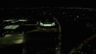 AX141_109 - 5.5K aerial stock footage flying by sports fields, approaching Harvard Stadium, Harvard University, Massachusetts, night