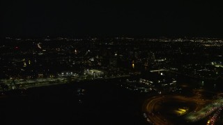 AX141_114 - 5.5K aerial stock footage flying by city lights, revealing Doubletree Suites, Allston, Massachusetts, night