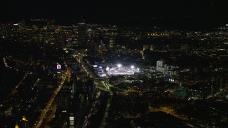 AX141_127E - 5.5K aerial stock footage flying by baseball game at Fenway Park, Downtown Boston, Massachusetts, night